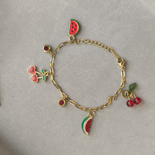 Playful fruit charms jewelry created as Prague souvenir