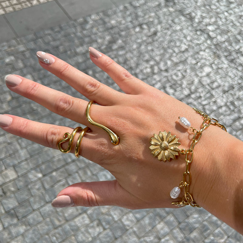 Customer wearing charm bracelet and rings by Charm Bar Prague