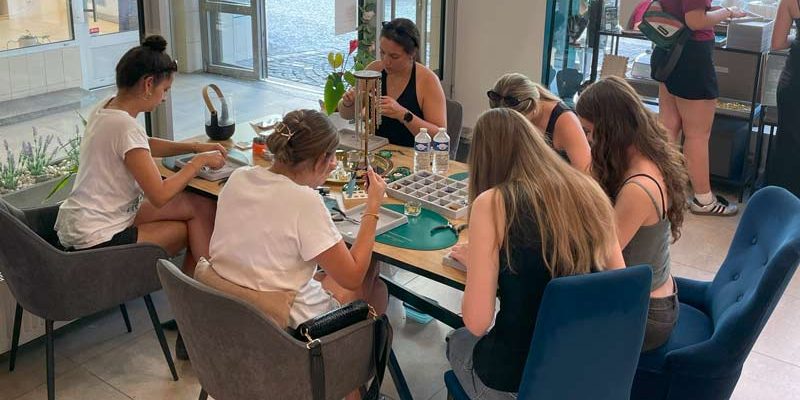 Visitors at Charm Bar Prague creating personalized jewelry with charms