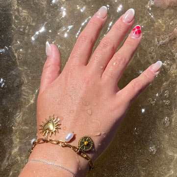 Tourist wearing her bracelet made in Charm Bar Prague by the sea