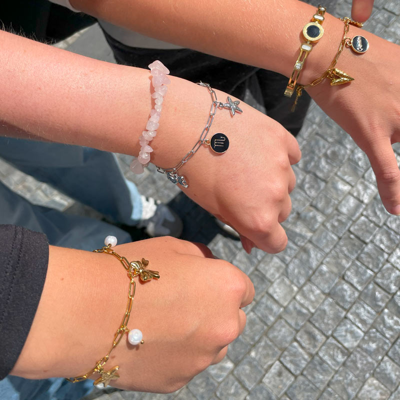 Close-up of charm bracelets made by friends at Charm Bar Prague