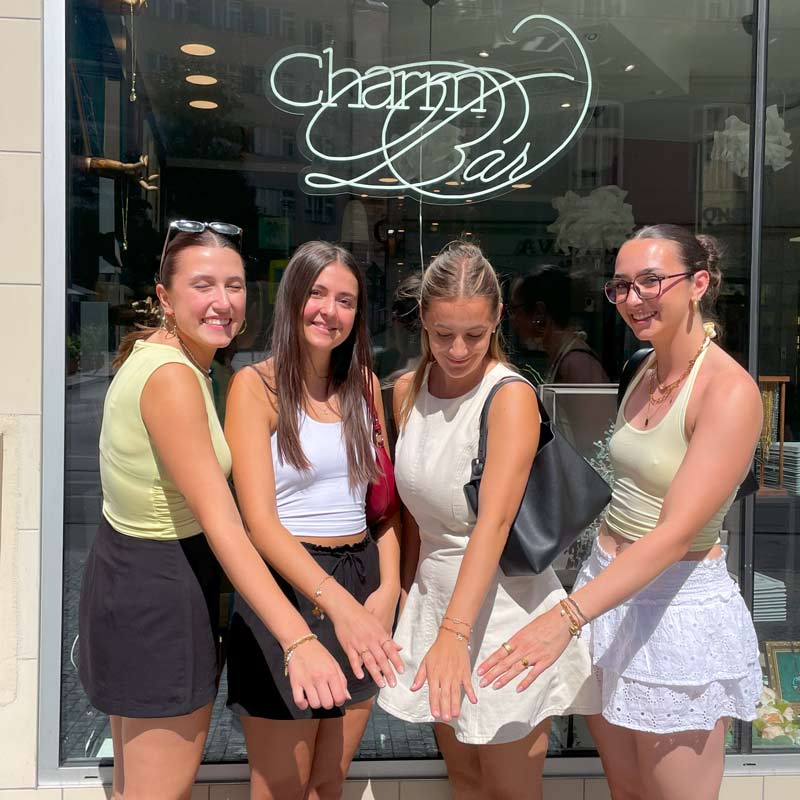 Group of friends showing their custom made bracelet from Charm Bar Prague